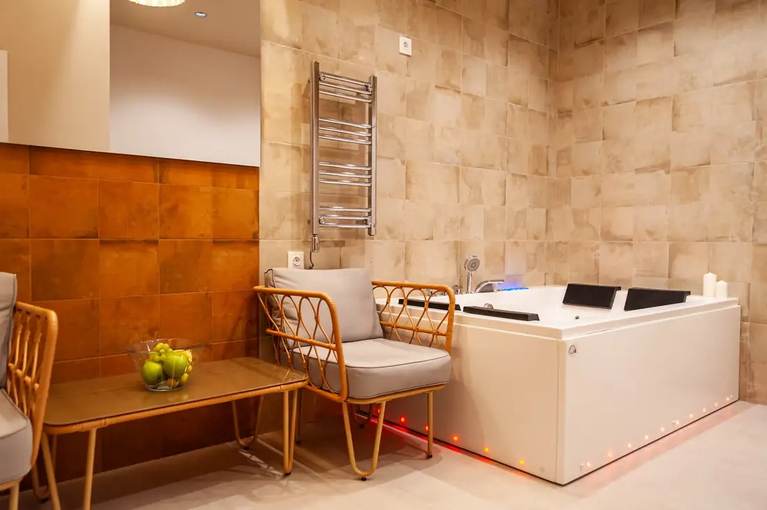 Two-person jacuzzi with a seating area beside it