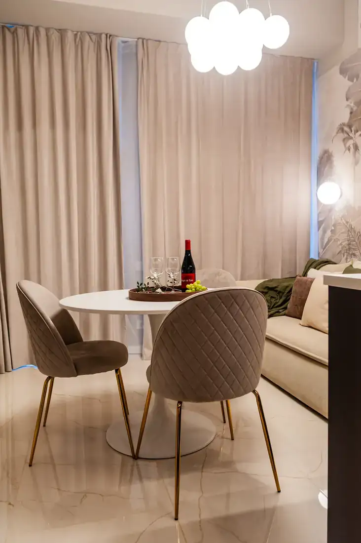 Television, dining table and panelled wall
